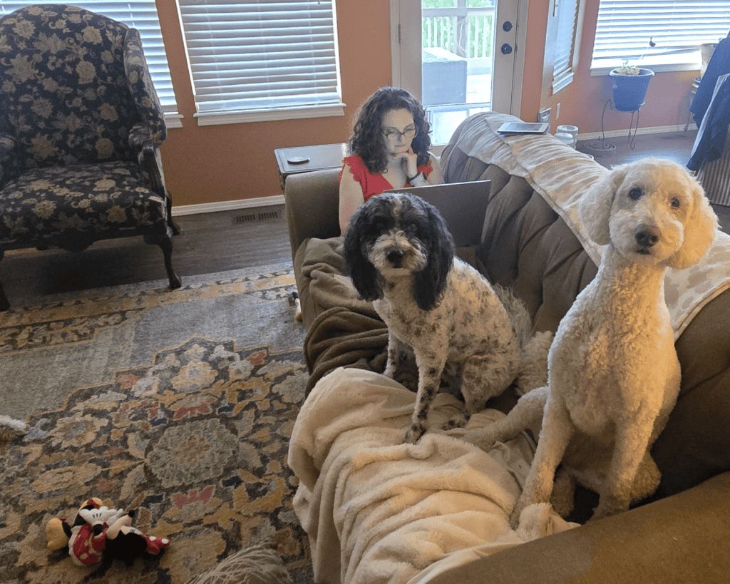 Dr. Degurse sitting on coach with dogs